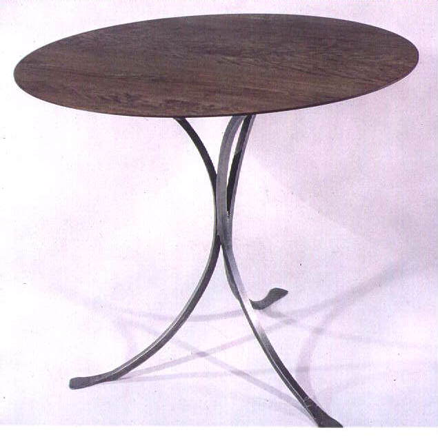 Round table with three arched legs